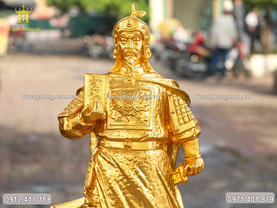 Tay phải của Ngài cầm cuốn Binh thư yếu lược